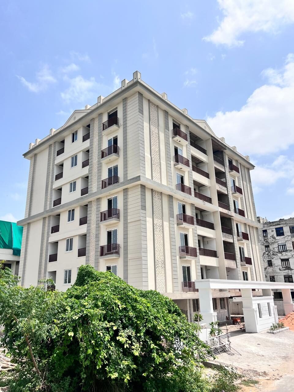 Corner view of Mangal Deep Apartments showing balconies and jaali detailing